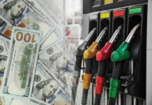Six-Dollar Diesel, Americans Slammed Again! Fuel pump nozzles next to spread of U.S. hundred-dollar bills