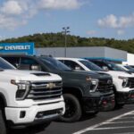 Chevy 350 RETURNS — In A Truck Row of pickup trucks at a dealership lot