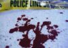 Midnight Hit Kills Football Boss Blood stains on a surface with police caution tape in the background