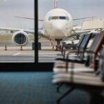 View of an airplane from an airport waiting area