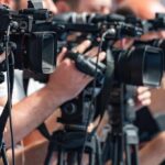 Music Kingmaker Dies television cameras on tripods at a media event