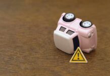 ALERT: Steering Fiasco Triggers Massive Auto Recall Upside down pink toy car next to a warning sign