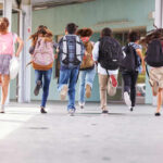 VIDEO: 3 Dead In School Shooting Children running with backpacks outside a school building.