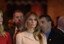 Melania Trump at an event with a crowd in the background