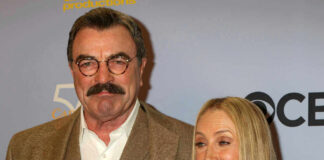 Tom Selleck posing with a blonde woman at a red carpet event