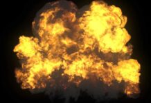 A large explosion with flames and smoke against a dark background