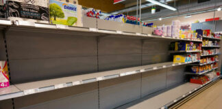 Empty supermarket shelves with sparse products displayed
