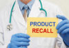 Scary Recall: Infant Baths Turn Deadly Doctor holding a product recall sign in gloves