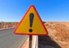 Surrogacy Mansion Horror Caught On Camera Triangular warning road sign with exclamation mark on a rural highway