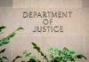 Illegal Firing Triggers DOJ Meltdown Sign displaying 'Department of Justice' on a stone wall
