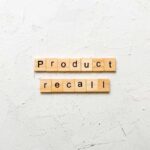 Wooden letter tiles forming words on a white textured surface