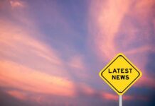 Public Death Plan Sparks Global Blowback Yellow diamond sign reading latest news against a colorful sunset sky