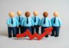 300,000 Hires – What’s The Catch? Business team figurines with rising red arrow