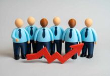 Business team figurines with rising red arrow