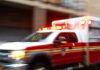Days Alone. Brutal Fall. Still Alive. Ambulance with flashing lights speeding through a city street
