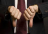 Shock Praise, Instant Washington Meltdown Two hands showing thumbs down in a suit.