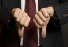 Shock Praise, Instant Washington Meltdown Two hands showing thumbs down in a suit.