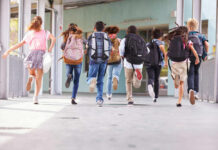 School Turns Tomb – Parents Kept In The Dark Children running with backpacks outside a school building.