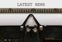 Lunch Lines Or Layoffs? Close-up of a typewriter with a sheet of paper displaying the words 'LATEST NEWS'